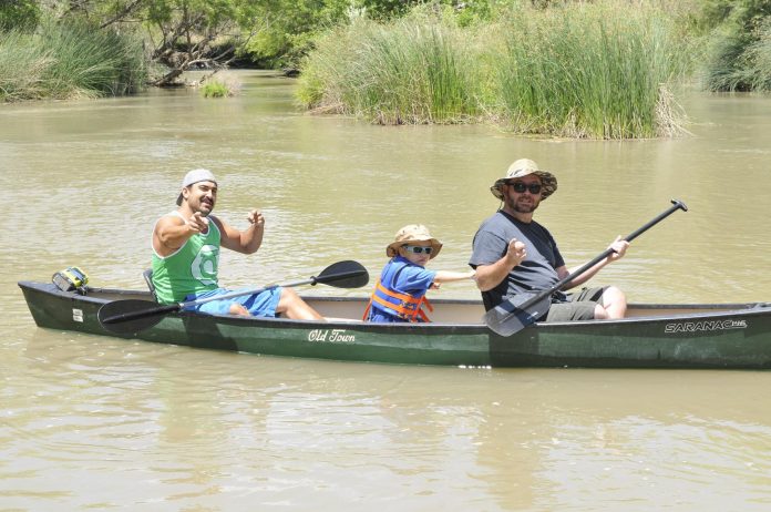 Brandon Savage, Brian Laxton and Rick Laxton, from left, paddle on the Verde River in Camp Verde by the Black Bridge, nearing the end of Brian’s first time on the river. One for the Verde workshops recently received a $3,000 grant to do safe river recreation, promoting this type of outing.