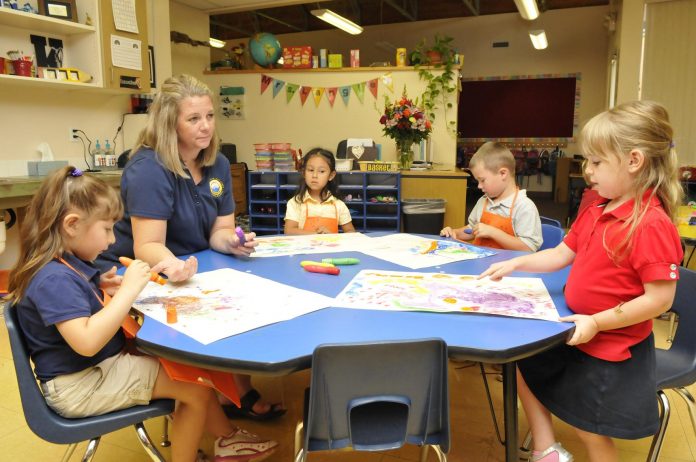 Heather Langley teaches kindergarten at Mountain View Prep, an International Baccalaureate school. Langley worked with students who were painting on Exploration Day. From left are Jaylah Basaldua Martinez, 5, Aliyah Florez Quiroz, 5, Bentley Murie, 5, and Cleo Gornick, 4.