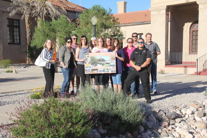 Members of Clarkdale’s municipal government hold a placard showing the Centennial Plaza plan. The plaza recently won the Program Excellence Award in the Community Sustainability category from the International City/County Management Association.