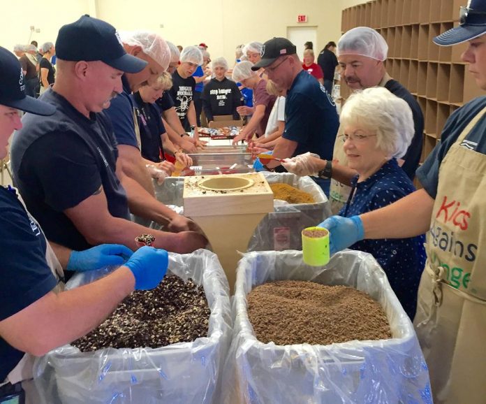 Volunteers pack nutritious meals during last year’s Kids Against Hunger meal-packing event. This year, organizers hope to pack 300,000 meals for distribution locally and to Haiti. Over half the meals stay in Yavapai County.