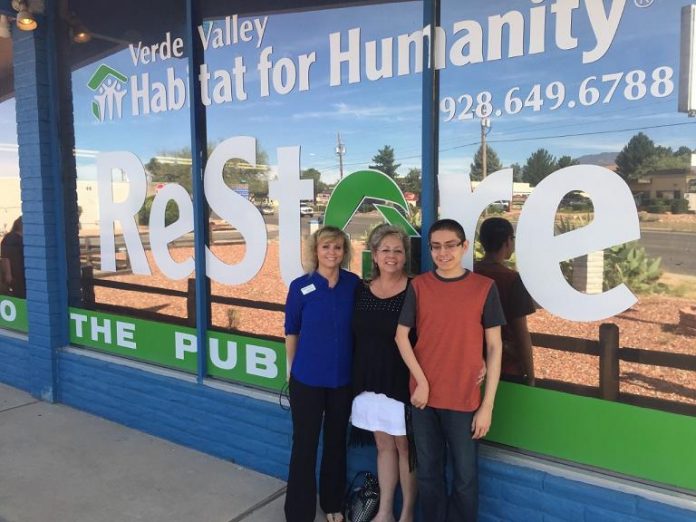 Verde Valley Habitat for Humanity Executive Director Tania Simms, Rachel Hernandez and Jaime Valenzuela stand before Verde Valley Habitat for Humanity's storefront. Hernandez and Valenzuela will soon see construction begin on their two-bedroom home in Cottonwood.