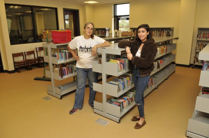 Camp Verde Community Library Youth Services Clerk Wendy Cook Roberts, left, and Youth Services Children’s Librarian Nadia Torabi work together to bring all the inventory from the old library building into the new one. The Camp Verde Community Library is set to open on Saturday, Nov. 5.