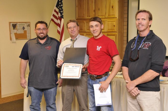 Mingus Union High School student Jacob Schwison receives his Student of the Month certificate from Valley Academy for Career and Technology Education Superintendant Bob Weir, center. Schwison was nominated by teachers Eric Banuelos, left, and Steve Darby, right.