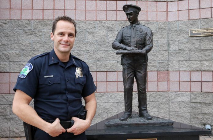 Cottonwood police chief Steve Gesell stands in front of the Law Enforcement Heroes Statue at the Cottonwood police station. The department is emphasizing the quality of life here in trying to recruit officers.