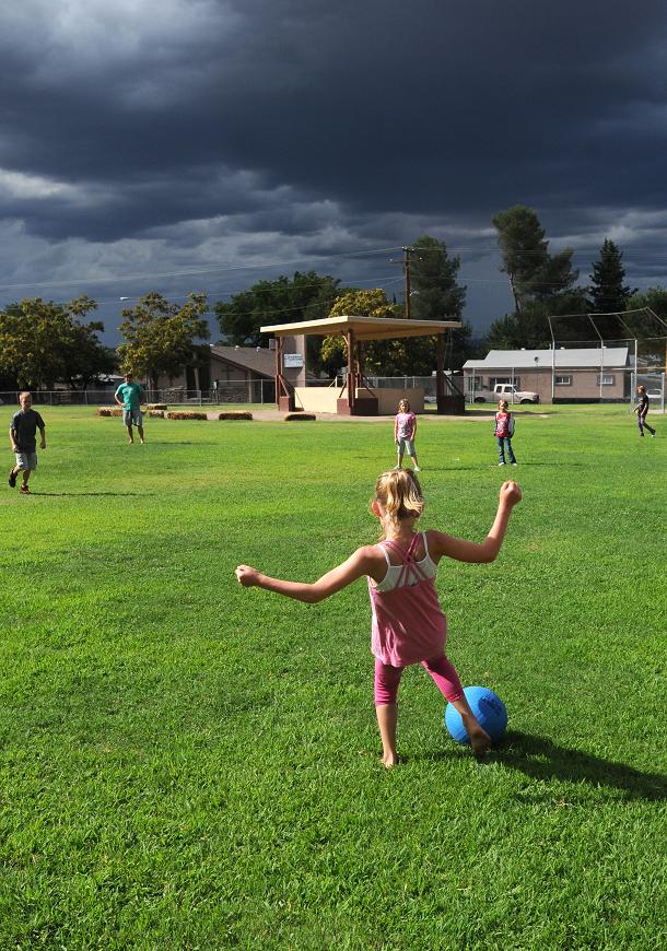 Sienna Shields, 8, plays kickball with other club members outside the Cottonwood branch of the Boys & Girls Clubs of Northern Arizona on Aug. 18. The umbrella of tax exemption on donations to the local club is possible because of the nonprofit status of the larger regional organization.