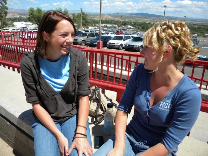 Kylee Heflin, a Mingus Union High School sophomore, right, discusses the pros and cons of the new six-period class schedule with her friend, sophomore Ashleigh MaKuchy.