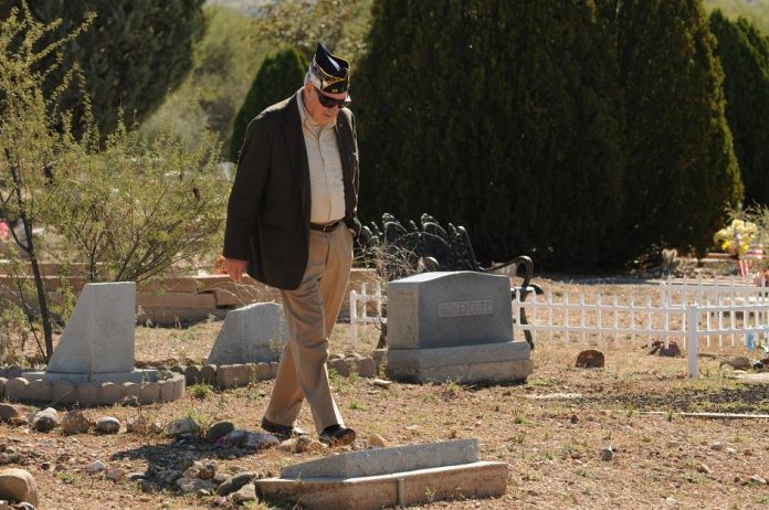 Ron Embly, a Korean War veteran who served with the U.S. Air Force from 1951 until 1955, walks among the grave sites at Clear Creek Cemetery shortly before the start of the American Legion Post 93 ceremony to commemorate Veterans Day on Thursday, Nov. 11. More than 240 U.S. veterans are buried in Clear Creek Cemetery.