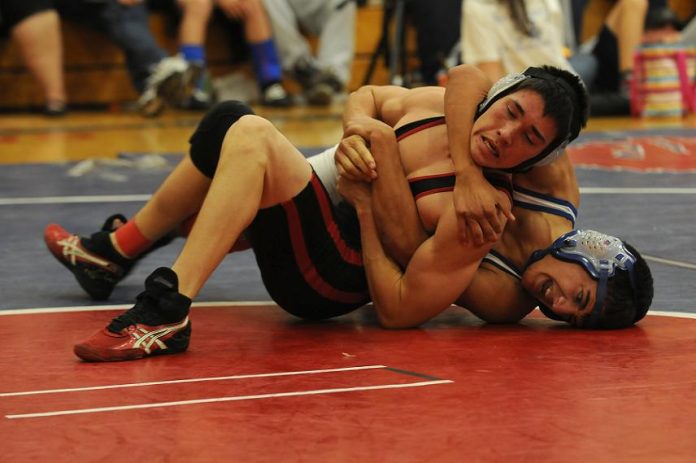 Roman Bux, bottom, a senior on the Camp Verde High School wrestling team battles a Benson High School opponent at the end of the two-day Verde Duels Tournament in Camp Verde on Friday and Saturday, Dec. 10 and 11.