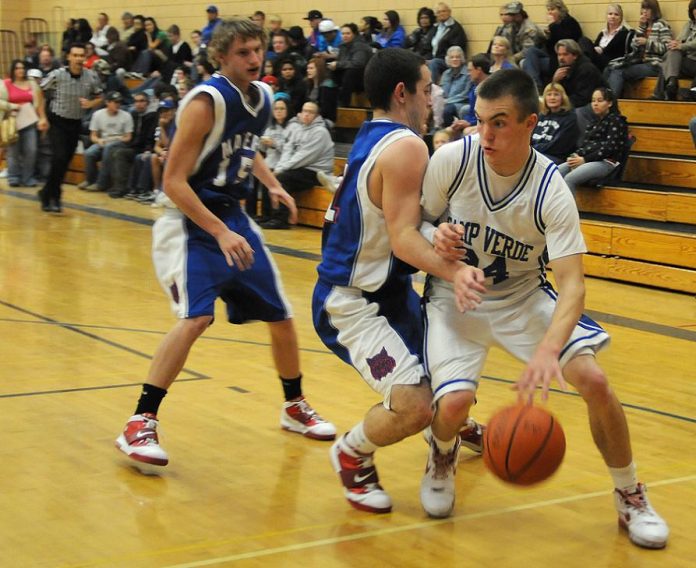 Jake Spleiss works his way around the Mayer High School defense in a home game Jan. 4. The Cowboys won the game, 63-25. Spleiss scored 22 points and grabbed 17 rebounds in a 58-43 win Saturday, Jan. 8, over Wickenburg High School.