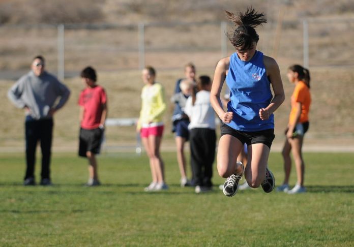 Sophomore Jenny Lawson jumps across the field during practice March 4. Lawson is a part of the girls track and field team for the Cowboys that could perform well this spring. The Cowboys finished fourth overall at the 1A-2A conference state meet last season.