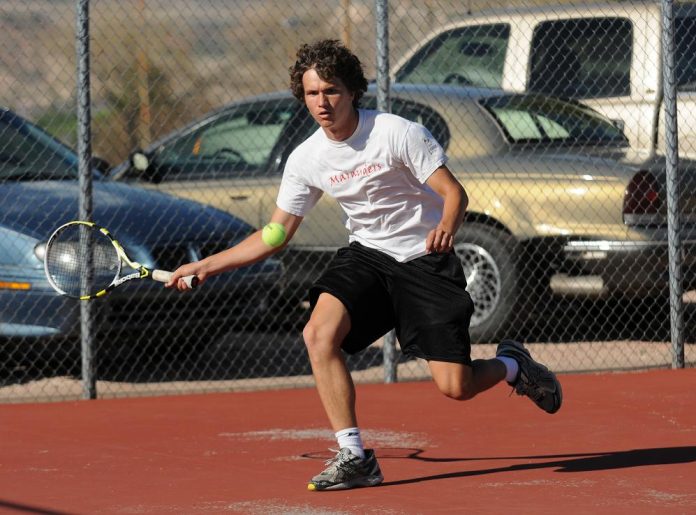 Mingus Union High School tennis player Austin Strobel returns hits from a Flagstaff High School player during a home match Tuesday, April 12.