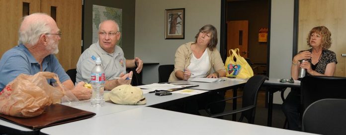 Members of the Verde River Basin Partnership outreach committee, including, from left, Ed Wolfe, Tony Gioia, Michelle Harrington, and Edessa Carr, work March 30 at the Verde Ranger District office on ideas for presentations around the Verde Valley during April which is Water Awareness month.