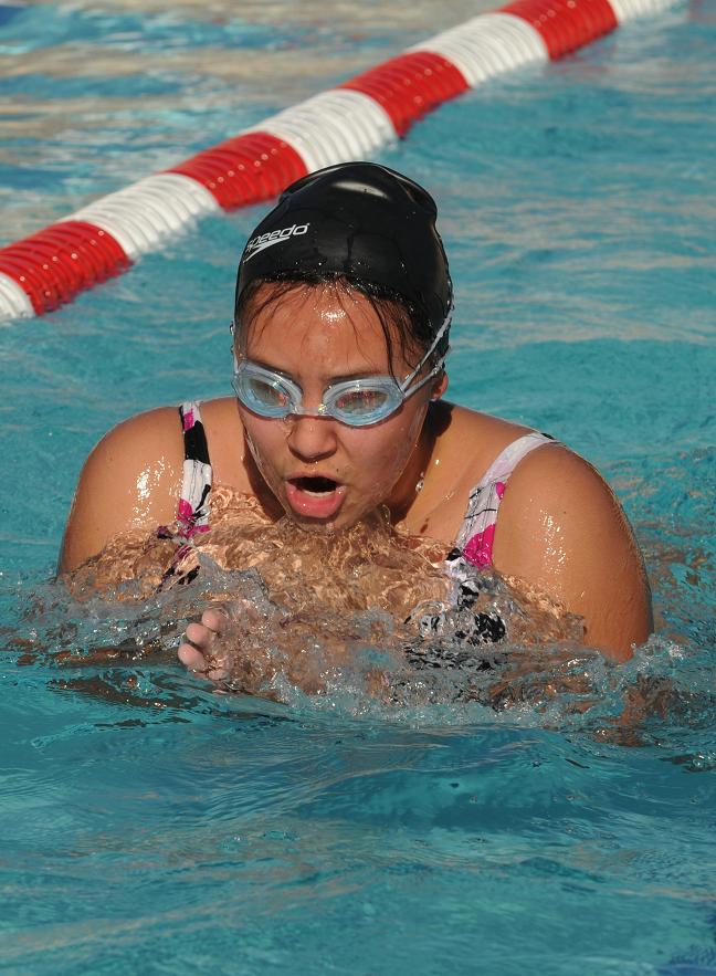 Alison Bauers, 14, works on her breaststroke while swimming laps at the end of practice in the Cottonwood Community Pool on Tuesday.