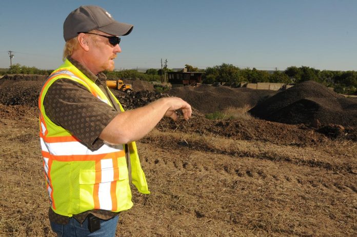 Steve Burroughs, a project manager for the Town of Camp Verde, explains Thursday, June 23, how town employees are using recycled asphalt and other road materials to make an affordable mixture for road repairs.