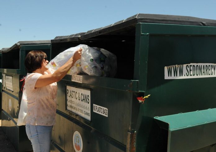 Rosemarie Shemaitis dumps plastic bottles into a Sedona Recycles collection bin located on city property at 535 S. Sixth St. Starting Friday, July 1, Verde Earthworks will replace Sedona Recycles as the Cottonwood vendor for recycling.