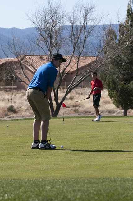 Bodie Holowell of the Camp Verde High School lines up his putt at a local golf course Wednesday, March 6.