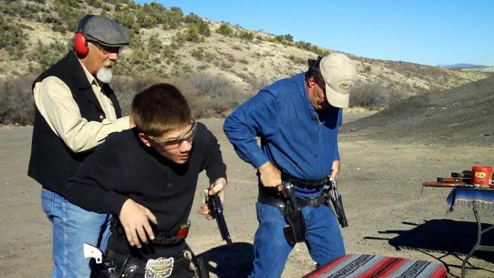 Clyde_Wasson, left, coaches Cody and Greg Kirkham at a shooting range near Camp Verde.