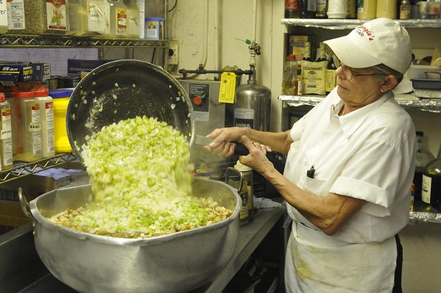 Peggy Reed adds onions and celery to a stuffing bowl once they are caramelized to her liking. Georgie’s Café hosts its 15th annual Thanksgiving dinner from 11 a.m. to 4 p.m. on Thanksgiving Day. Last year, the Cottonwood restaurant served 1,700 meals.