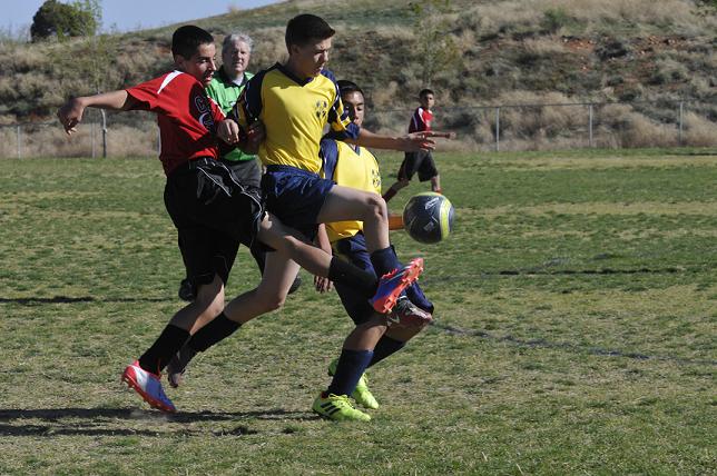 Bryce Contreras, left, of Cottonwood Middle School attempts to steal possession from Mountain View Prep eighth-graders Wesley Loveall, center, and Chris Luna during their 1-1 tie April 1.