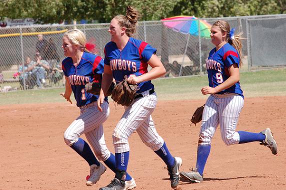 Senior Caitlin Harris, left, is congratulated by sophomores Dusty Dowdle, center, and Paige Church after her stab of a hot infield ground ball was able to get the final out of the second inning for Camp Verde High School in the Cowboys’ 5-2 loss to Payson High School in the Division III state quarterfinals Saturday, May 10, at Rose Mofford Softball Complex in Peoria.