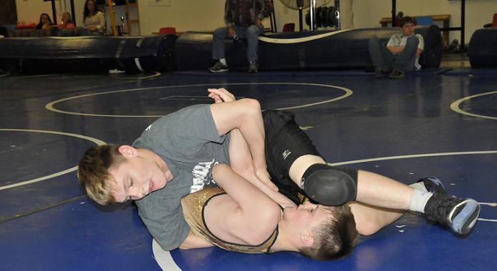 Hayden Uhler, left, an incoming sophomore at Camp Verde High School, pins younger brother Korben, a seventh-grader at Camp Verde Middle School, in preparation Friday, May 30, for Weekend Wars every other summer Saturday at the Sterrett Wrestling Complex.