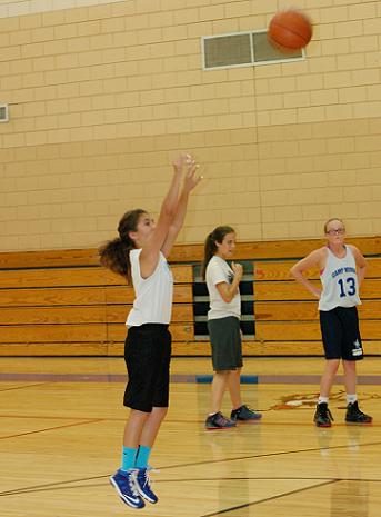 Senior Rayana Chatter, left, practices her jump shot as Lucy Showers, and seventh-grader Destiny Dowdle, No. 13, wait their turn in line during practice June 23, the day after the Cowboys’ championship of the Summer Slam basketball tournament in San Diego.