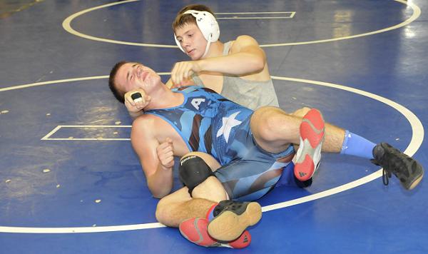 Senior Ryan Allred, in headgear, seeks to become only the second Camp Verde High School wrestler to win four championships in four years, forcing a takedown July 5 during Weekend Wars. Allred is one of four Cowboys who received a scholarship to attend a week of Wrestling Prep, a national wrestling camp in California