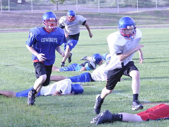 Freshman John Taylor, left, steams just behind freshman William Webster, right, and ahead of sophomore Jesus Curiel during a running drill at Camp Verde High School practice.