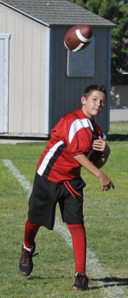 Eighth-grader Antoine Zabala throws a pass at practice the day before Cottonwood Middle School's first game Saturday, Aug. 30, at Chino Valley High School.