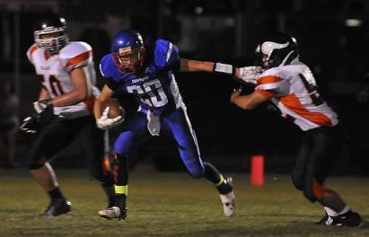 Senior Jordan Reay holds the Williams High School defense at arm’s length as he maneuvers his way closer to a touchdown that would give Camp Verde High School the early 7-0 lead during the CVHS homecoming game. The Cowboys fell to 1-3 with a 27-18 loss.
