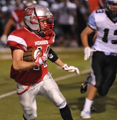 Junior Tristan Clark, No. 44, takes the ball and runs, relying on teammates to clear the way in the first half of Mingus Union High School's 41-14 loss to the Cactus Cobras in its home opener.