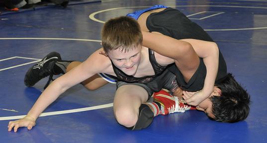 Seventh-grader Korben Uhler, top, of Camp Verde Middle School, fights to gain leverage over his opponent at the Sterrett Wrestling Complex during the last Weekend Wars of the summer. Uhler was named outstanding lightweight of the summer tournament and is looking for his first state title at 104 pounds.