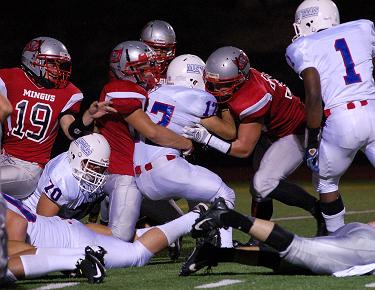 Mingus Union High School sophomore defensive back Trey Meyer, No. 19, and his teammates converge on North High School senior running back Brian Yazzie in the Marauders’ first win, 40-14 over the visiting Mustangs.