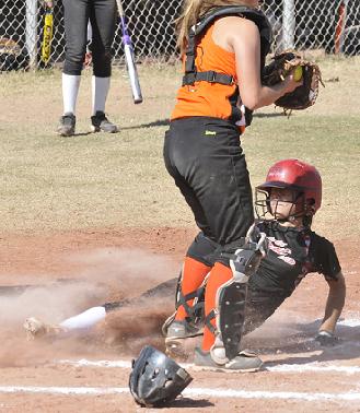 Maliah Zillmer, a sophomore at Mingus Union High School, slides into home plate for the Verde Valley Heat Elite club softball team — but not before the throw was caught by the catcher for the Her-ricanes to put her out. The Heat won all four of its consolation games to take third place in the second annual Cottonwood Classic for fast-pitch girls softball players ages 14 and under.
