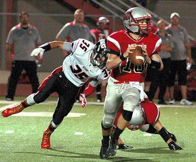 Junior quarterback Jordan Upham looks for an open receiver while under pressure from Bradshaw Mountain High School during Mingus Union High School's 34-14 home loss Friday, Sept. 26.