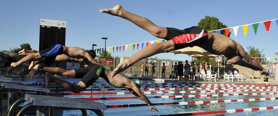 Freshman Gunner Tillemans, of the Mingus Union High School boys swim team, front, dives into the pool, competing against several other high schools in the Brophy and Xavier College Prep Invitational last week.