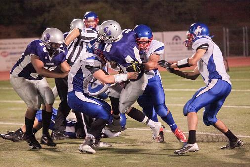 Three defenders for Camp Verde High School converge on Sedona Red Rock High School junior quarterback Derrick Johnson, No. 14, for the sack during the Cowboys’ 35-6 loss Friday, Sept. 26, at the Scorpions.