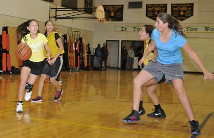 Kaitlyn Card, left, dribbles toward the basket as eighth-grade teammate Lilly Sanchez holds off the opposition during a Clarkdale-Jerome School girls basketball team practice.