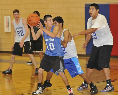 Junior Javier Perez, No. 10, looks for an opening in the defense to exploit at Camp Verde High School basketball practice.