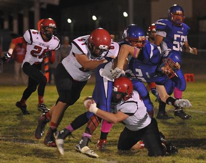 Senior Jordan Reay's run for Camp Verde High School was cut short by two Lee Williams High School defenders in the Cowboys' home loss Oct. 3. Reay finished with nearly 1,900 career rushing yards as the Cowboys won at Willcox High School to finish 3-7.