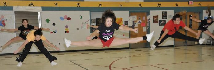 Kayla Renken, center, is one of the returning Camp Verde High School cheerleaders who will be running a mini-camp for aspiring cheerleaders beginning at 4 p.m. Monday, Jan. 5. Renken, a senior, is the daughter of CVHS assistant cheer coach Marie Worland.