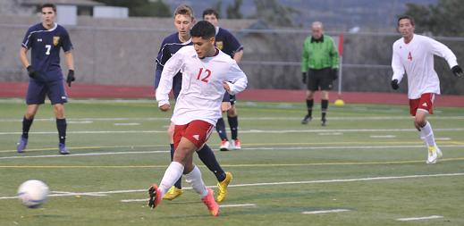 Senior Hector Zapata, No. 12, passes the ball to an open Mingus Union High School teammate closer to the goal Dec. 15 against visiting Glendale Prep. Zapata had a goal in the Marauders’ 2-0 shutout Thursday, Dec. 18, at Northwest Christian High School.