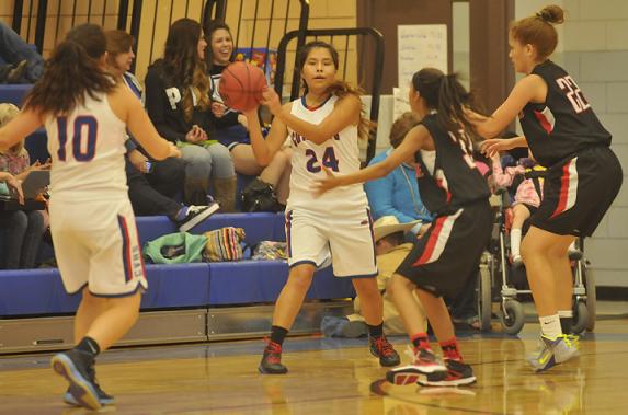 Gerlaura Vaughn, No. 24, looks for fellow senior guard Gabby Ontiveros, No. 10, or another open teammate to pass to at Camp Verde High School as she is crowded by the Glendale High School defense. The Cowboys defeated the Cardinals at home Friday, Jan. 16.