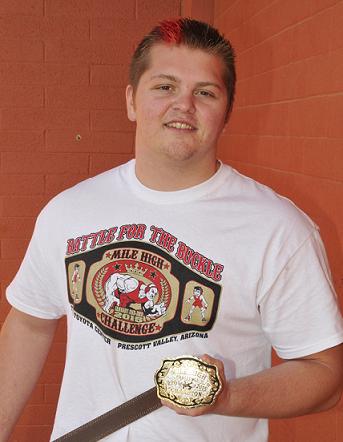 Wyatt Midkiff shows off his Mile High Challenge champion belt buckle, the trophy he received for winning the 220-pound weight class. Midkiff, a senior 220-pound wrestler at Mingus Union High School, competed in the challenge despite having only just been cleared by a doctor for a skin infection.