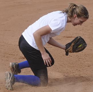 Sophomore Kayla Hackett makes a diving catch at third base for Camp Verde High School in a scrimmage against Mingus Union High School. The Cowboys won the game Friday, Feb. 20, against the Marauders.