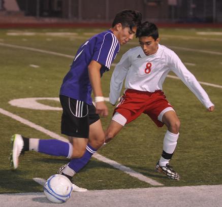 Junior midfielder Martin Hernandez, No. 8, engages in a high-speed struggle over control of the ball with Sedona Red Rock High School senior Jose Aviles-Moya, heading towards the Mingus Union High School goal. The Marauders knocked the Scorpions out of the Division III playoffs in the first round before falling at home Saturday, Feb. 7, to Coronado High School.