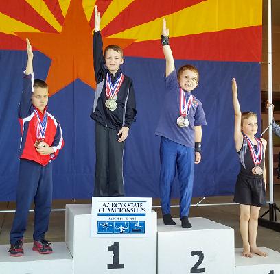 Brennan Reilly, center, an 8-year-old home-schooled Cottonwood gymnast, won three events March 14 at the Arizona State Boys Gymnastics Championships in Chandler. Reilly also took home the all-around title for having the highest score out of more than 120 competing gymnasts.