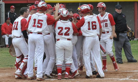 The Mingus Union High School baseball team comes out of the dugout to celebrate freshman Tyler Kelly’s home run. Kelly hit his first pitch over the left field fence for the three-run homer against Verrado High School.