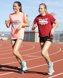 Junior Megan Goettl, left, warms up with freshman Sydney Alexander at Mingus Union High School track practice. Goettl will be running relay as well as the 800 meters at the Division III championships Friday and Saturday, May 8 and 9, as the Marauders go for their fourth straight girls state team title.