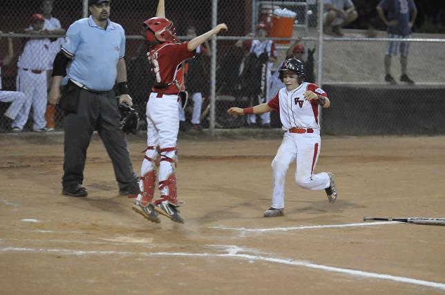 Zach Harrison, of the Verde Valley Majors, arrives safely at home as the Camp Verde catcher reaches high for the throw to plate in their playoff game July 1 at Riverfront Park. VVLL easily defeated Camp Verde, 16-5, to advance to the next round.